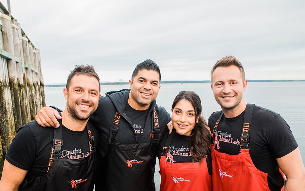 A picture of Cousins Maine Lobster franchisees with Jim & Sabin, the founders of Cousins Maine Lobster
