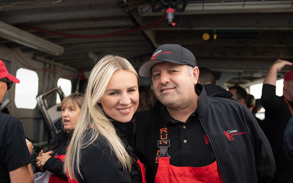 A photo of our Freehold Franchisees standing in fishing gear, smiling.